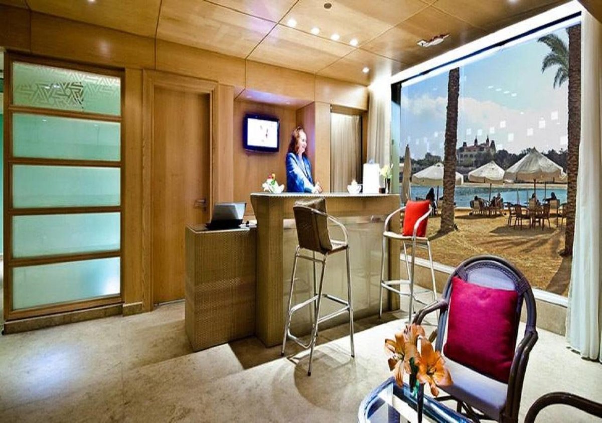 Palestine Montaza Alexandria reception area with wood-paneled walls and a large window.