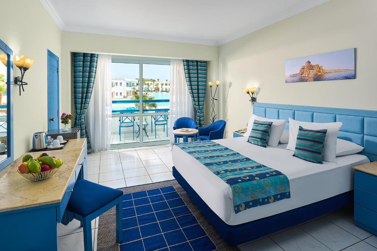 Dreams Vacation - Sharm El Sheikh guest room with balcony and pool view.