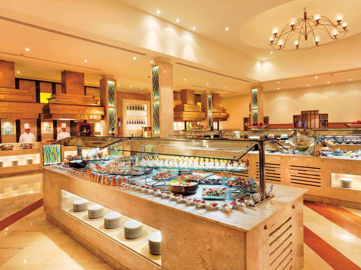 Movenpick Resort & Spa El Gouna buffet area with glass food displays and wooden counters.