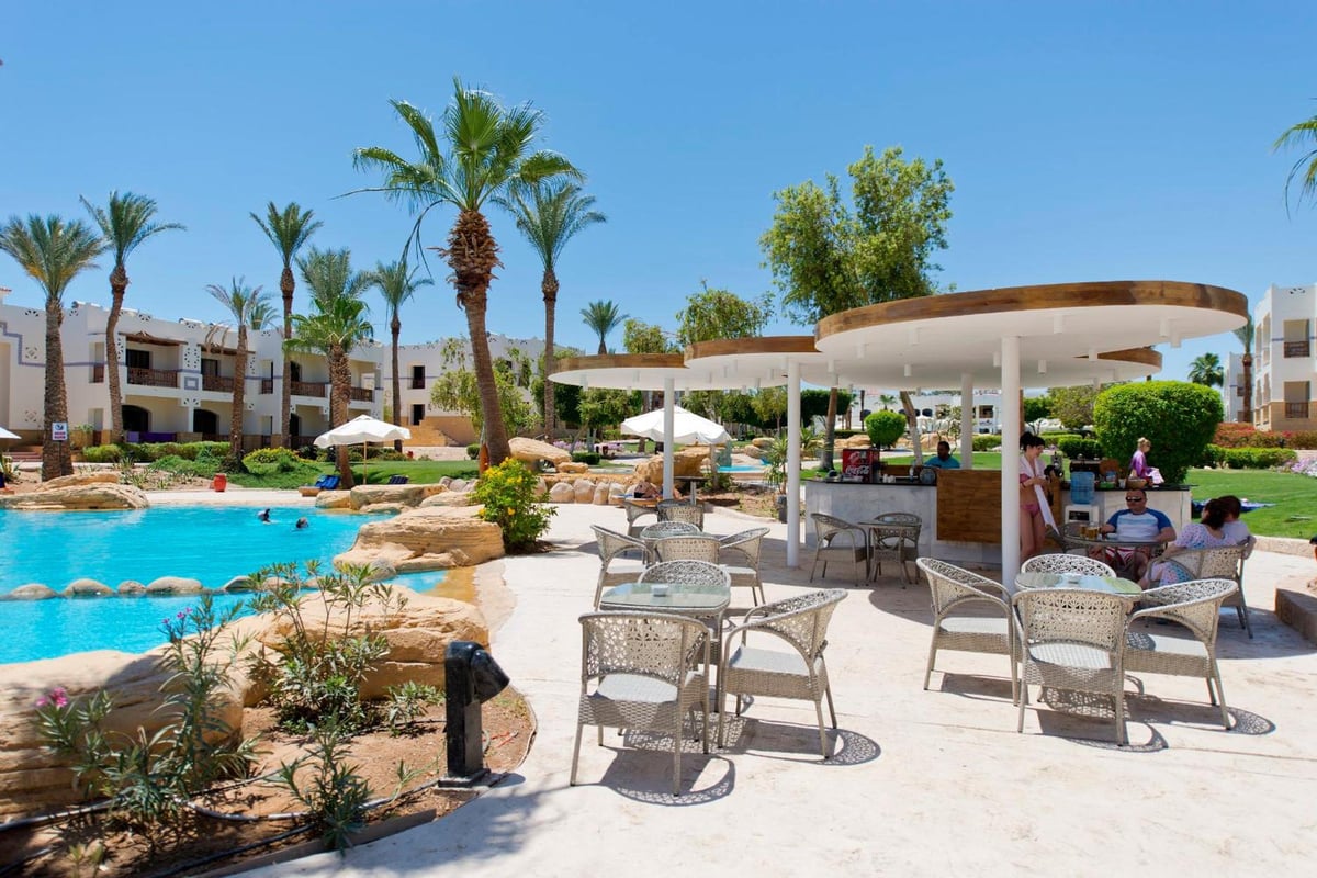 Amphoras Beach Ultra All Inclusive poolside bar with a bar counter and shaded seating.