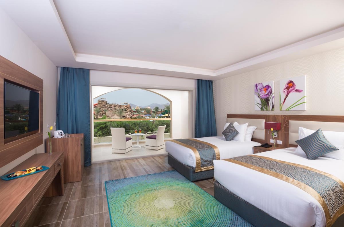 Pickalbatros Aqua Blu Sharm El Sheikh twin bedroom with two single beds and a balcony.