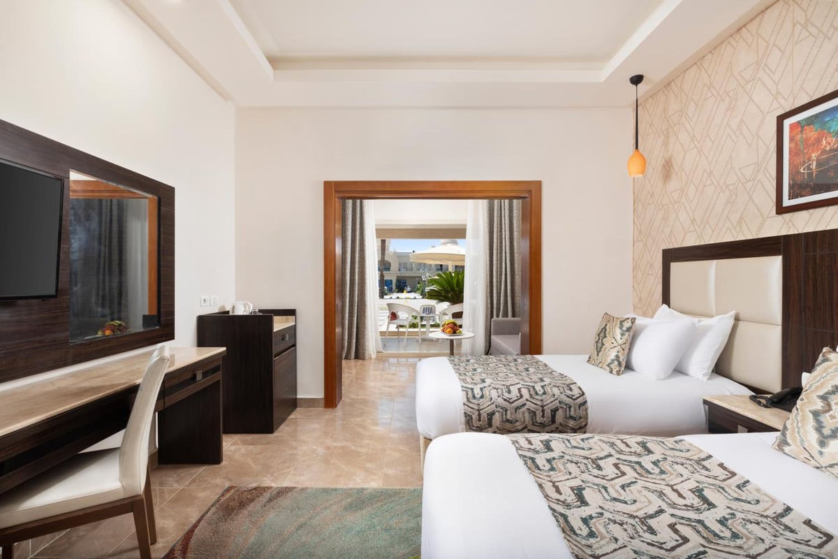 Pickalbatros Aqua Blu Sharm El Sheikh twin bedroom with twin beds and a balcony.