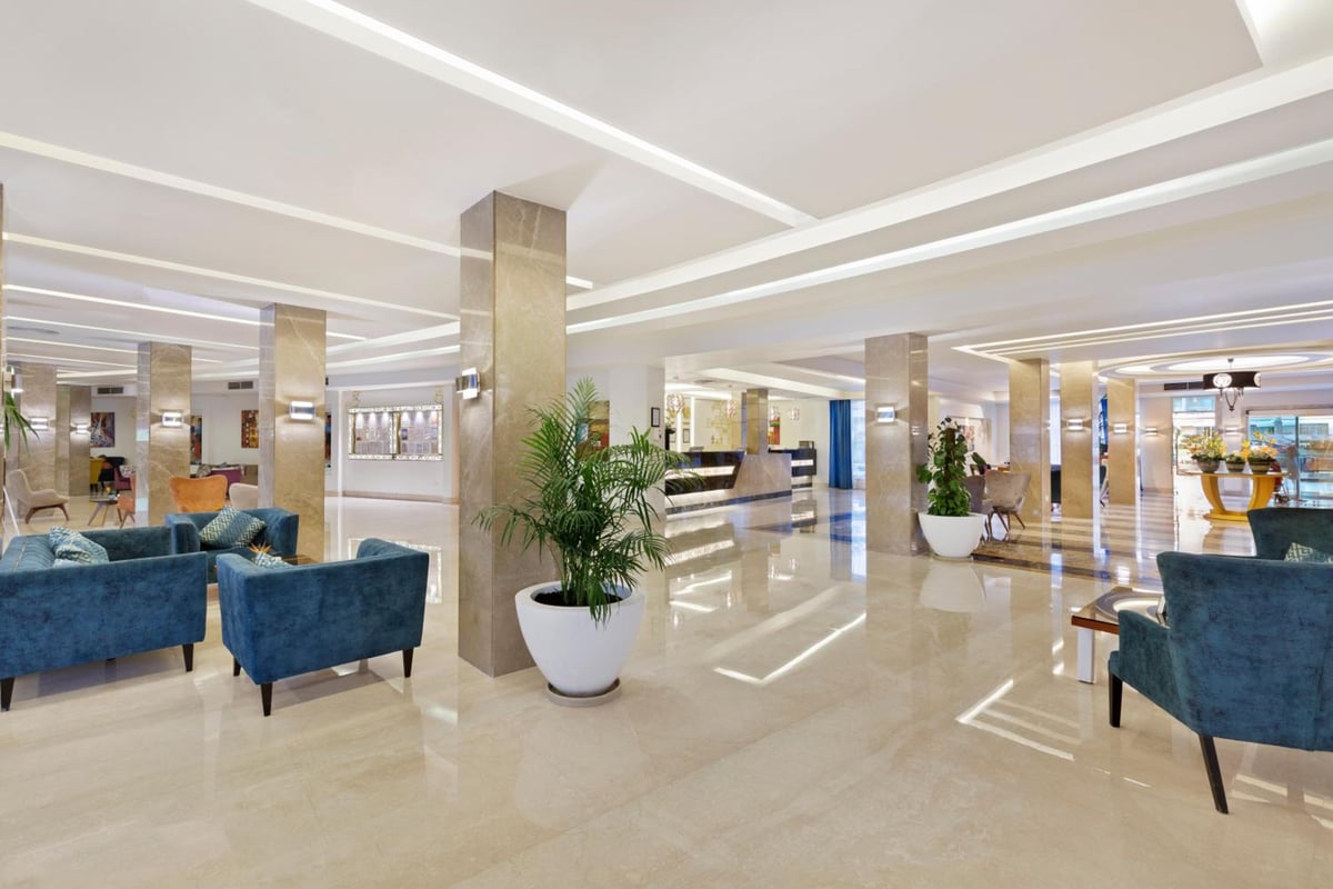 Pickalbatros Aqua Blu Sharm El Sheikh lobby with polished floors and blue lounge seating.