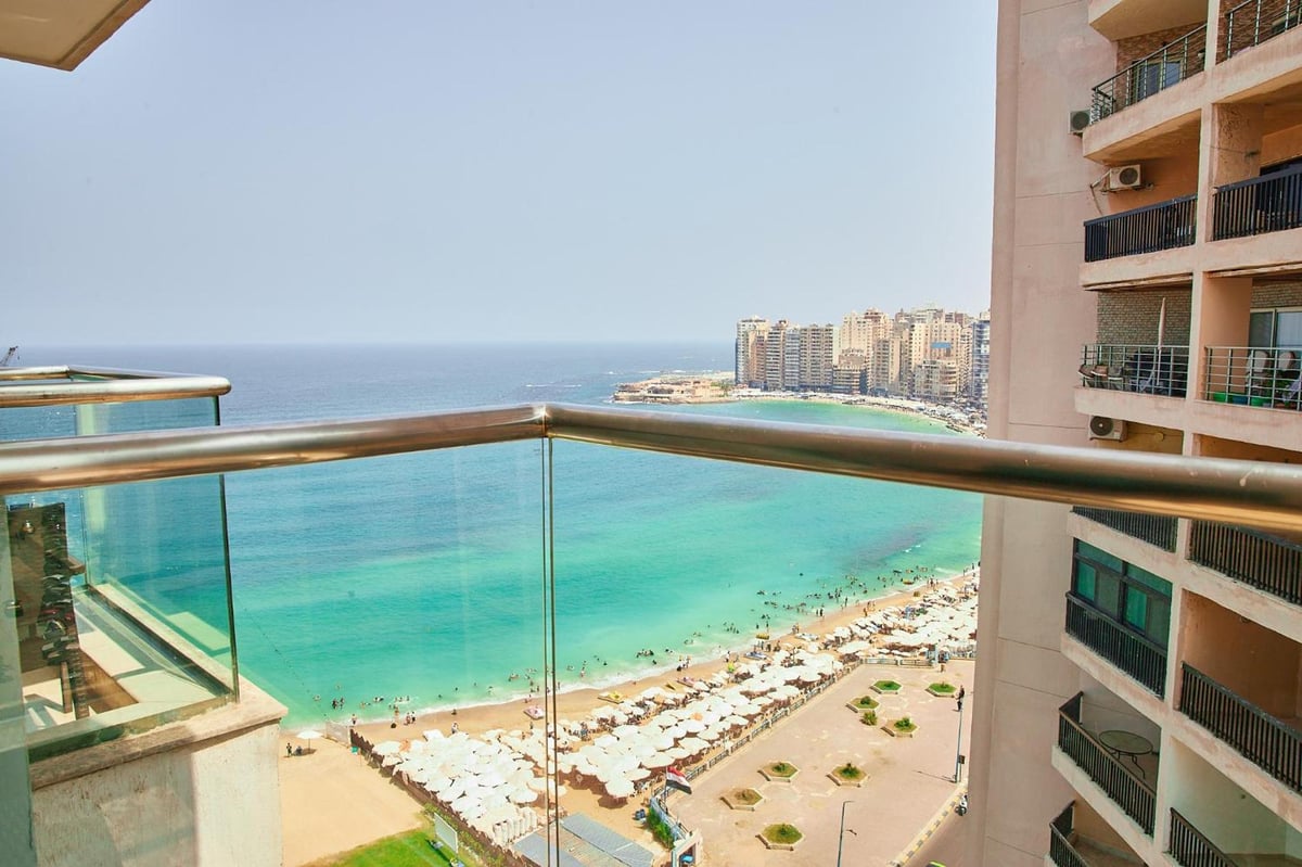 Hilton Alexandria Corniche balcony with a glass railing and sea view.