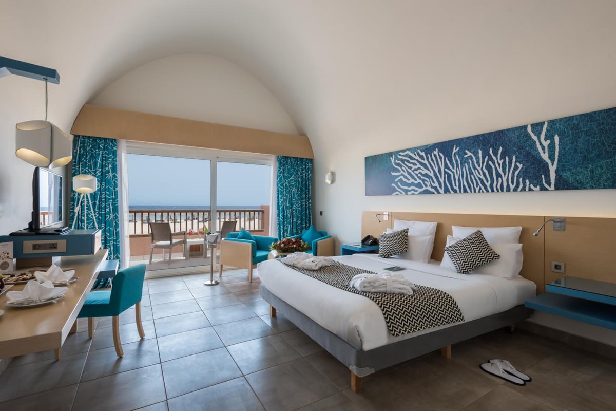Novotel Marsa Alam Beach Resort bedroom with a double bed and a balcony overlooking the sea.
