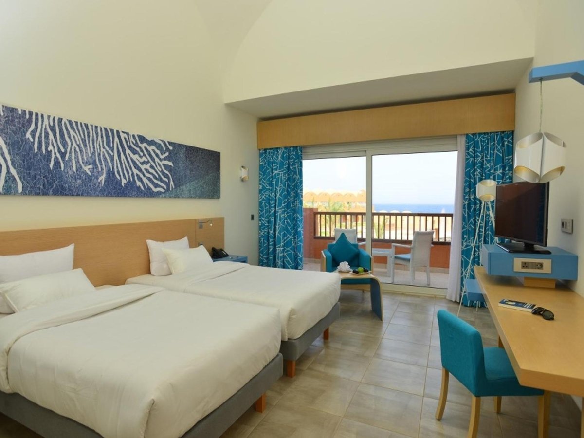 Novotel Marsa Alam Beach Resort twin bedroom with two beds and a balcony.