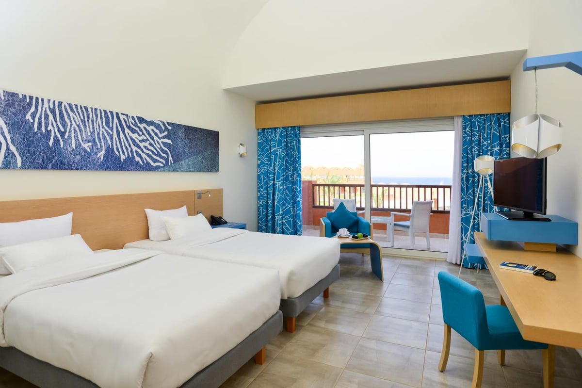 Novotel Marsa Alam Beach Resort guest room with two beds and a balcony.