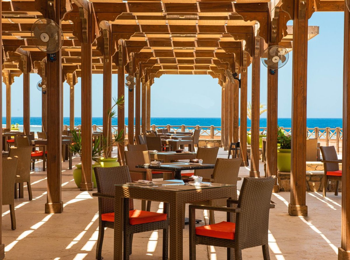 Novotel Marsa Alam Beach Resort restaurant terrace with a wooden pergola and sea view.
