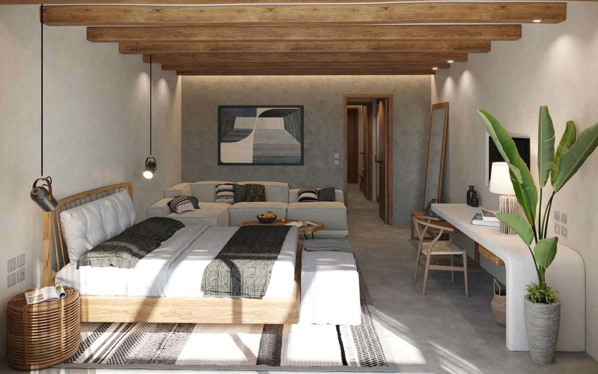 JAZ Elite Riviera guest room with a low bed and a sitting area.