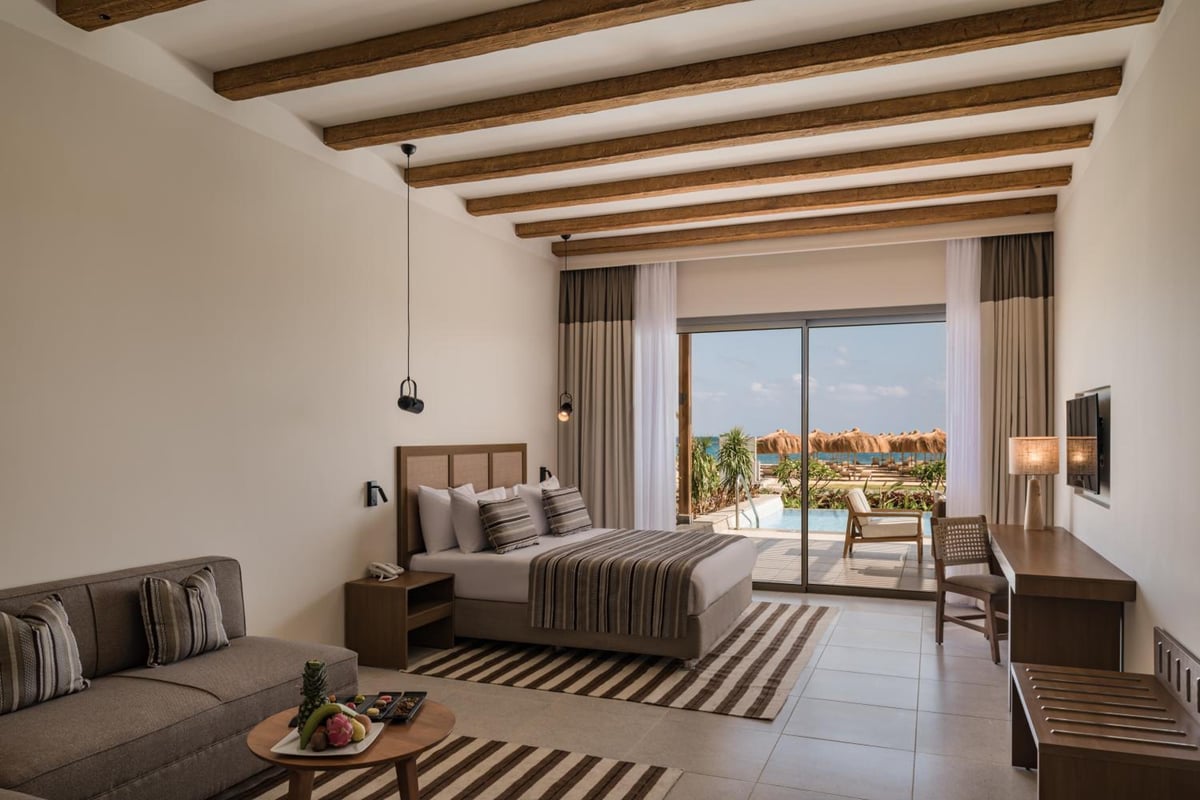 JAZ Elite Riviera guest room with a bed and balcony.