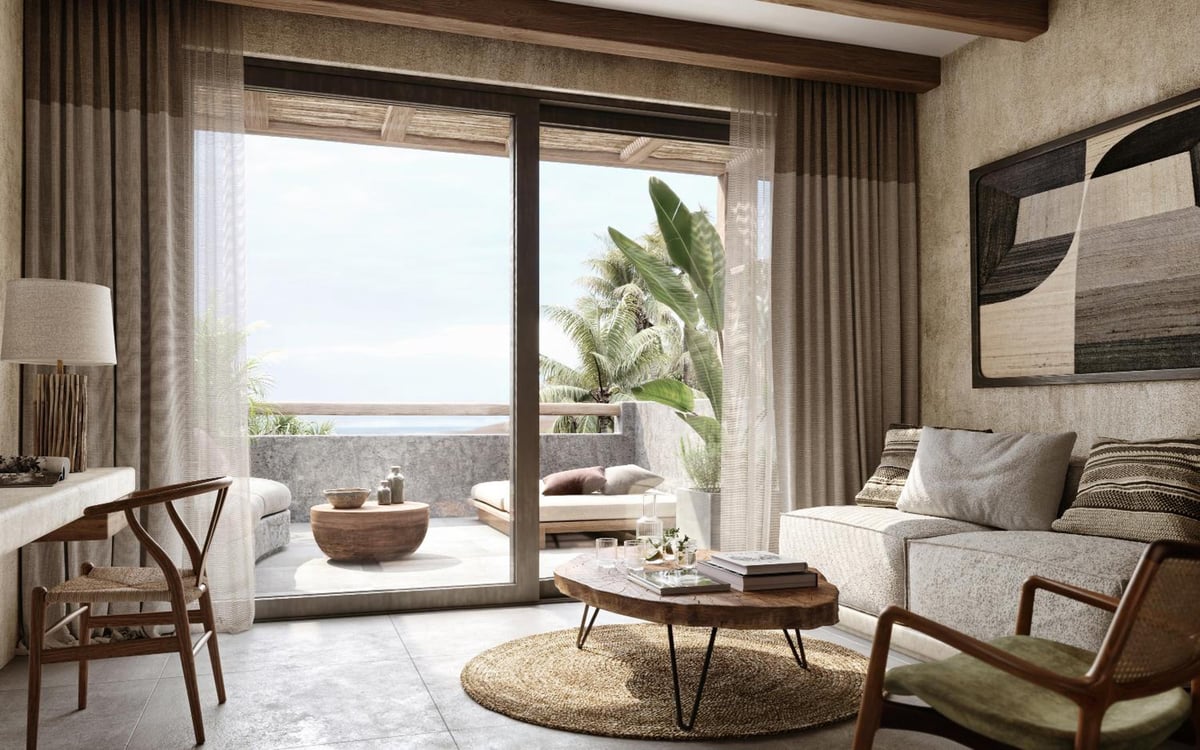 JAZ Elite Riviera living room with a sofa and sliding glass doors.