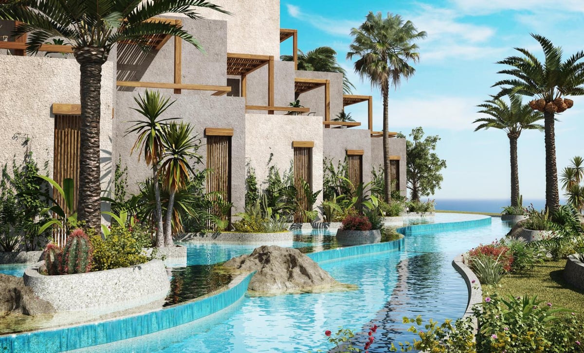 JAZ Elite Riviera pool area with a curved edge and palm trees.
