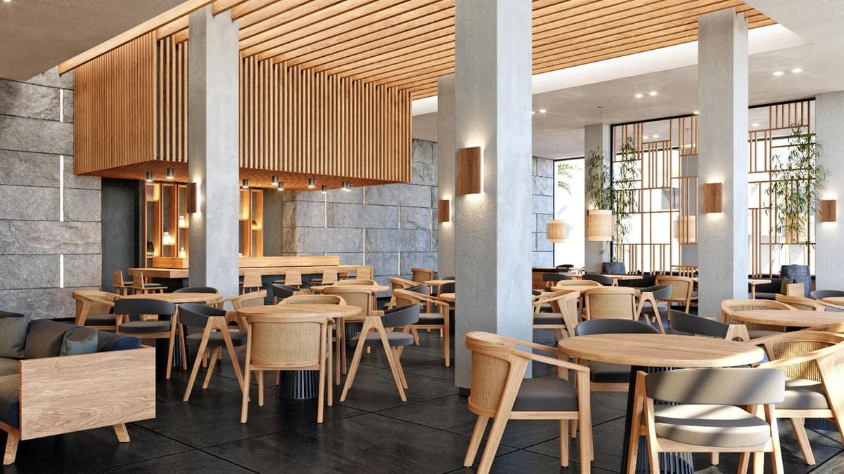 JAZ Elite Riviera restaurant dining area with a slatted wood ceiling and stone walls.