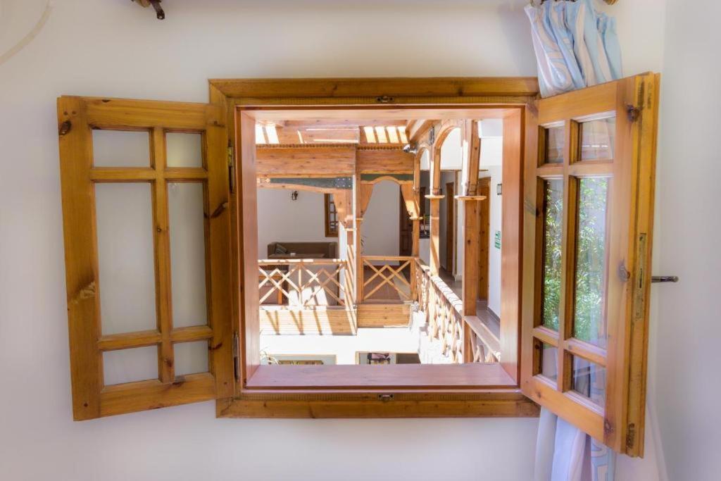 Acacia Dahab Hotel room window with open wooden shutters and a covered balcony.
