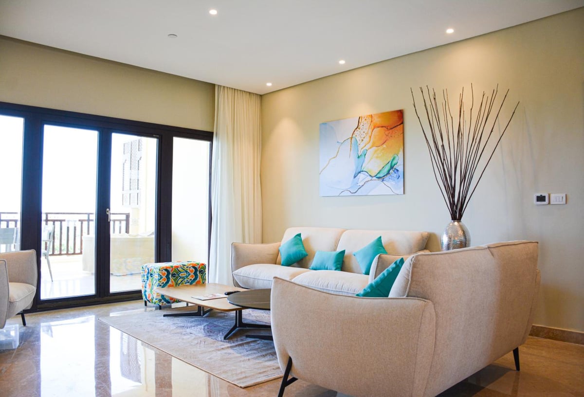 Steigenberger Aldau Beach Hotel living room with beige seating and abstract wall art.