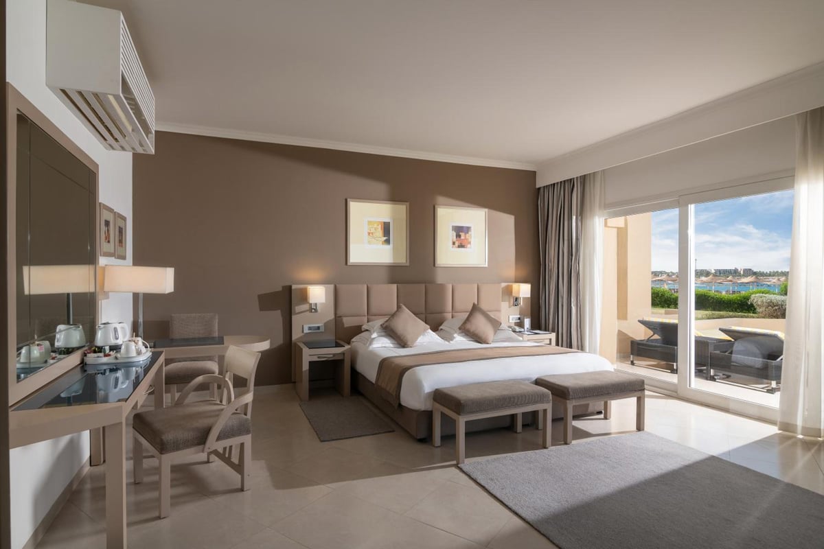 Cleopatra Luxury Resort Makadi Bay guest room with twin beds and sliding balcony doors.