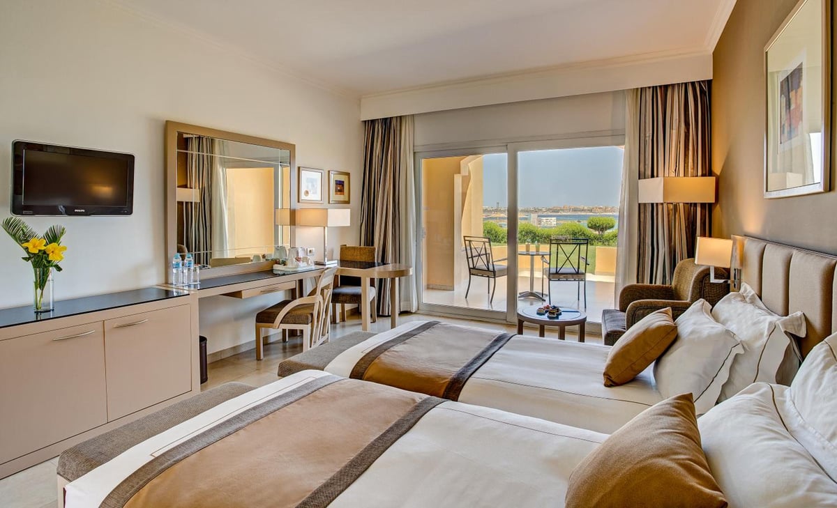 Cleopatra Luxury Resort Makadi Bay twin bedroom with two beds and a balcony.