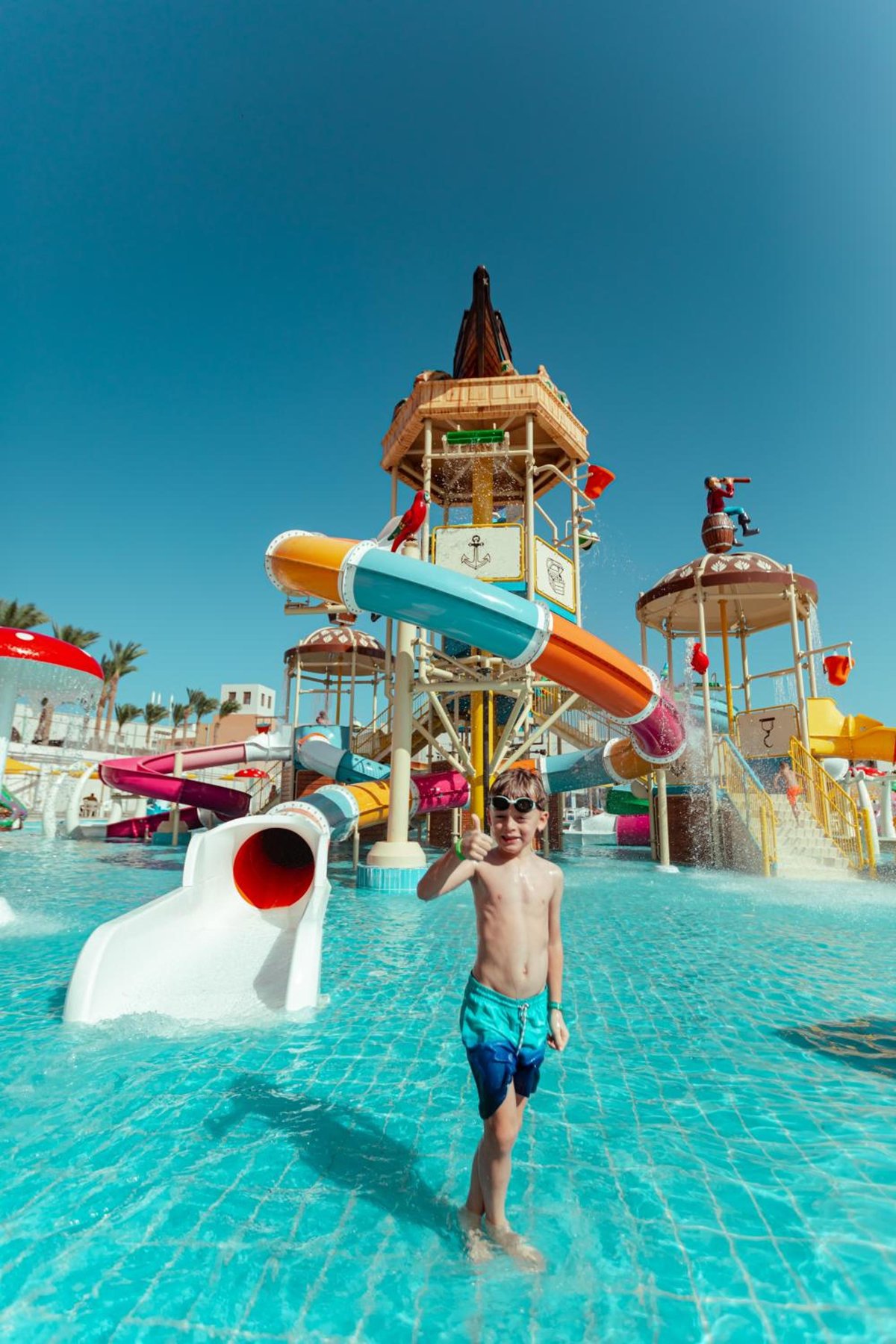 Pickalbatros The Palace Port Ghalib water park pool with colorful slides and shallow water.
