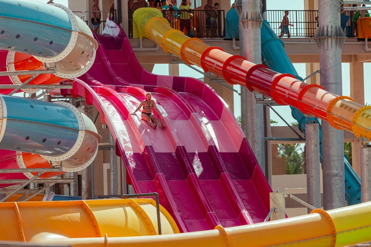 Pickalbatros The Palace Port Ghalib water park with colorful slides and enclosed tube slides.