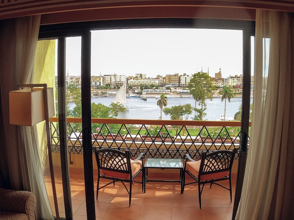 Movenpick Resort Aswan balcony with a river view and lattice railing.