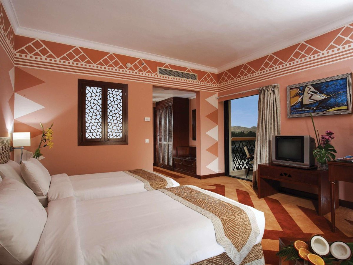 Movenpick Resort Aswan twin bedroom with two beds and a balcony.