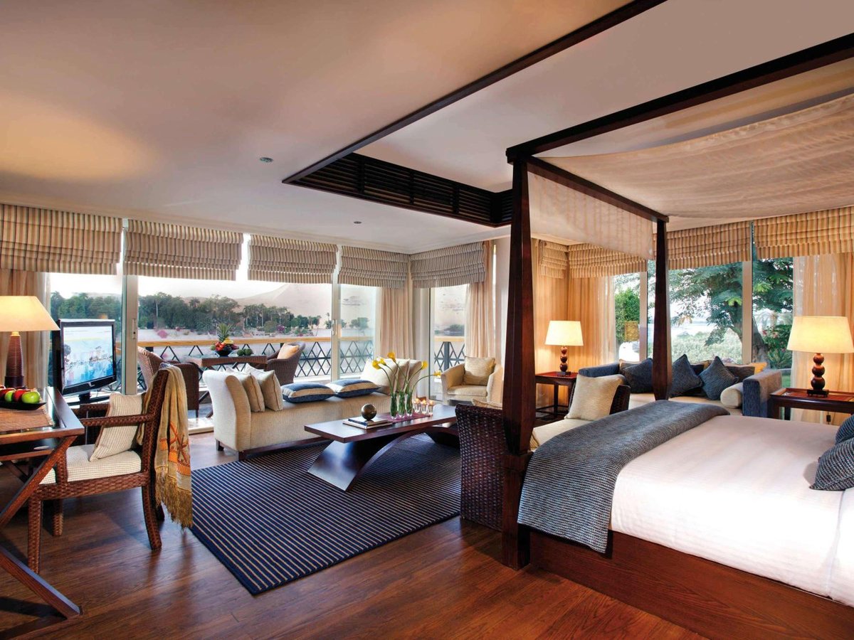 Movenpick Resort Aswan guest room with a bed and adjoining sitting area.