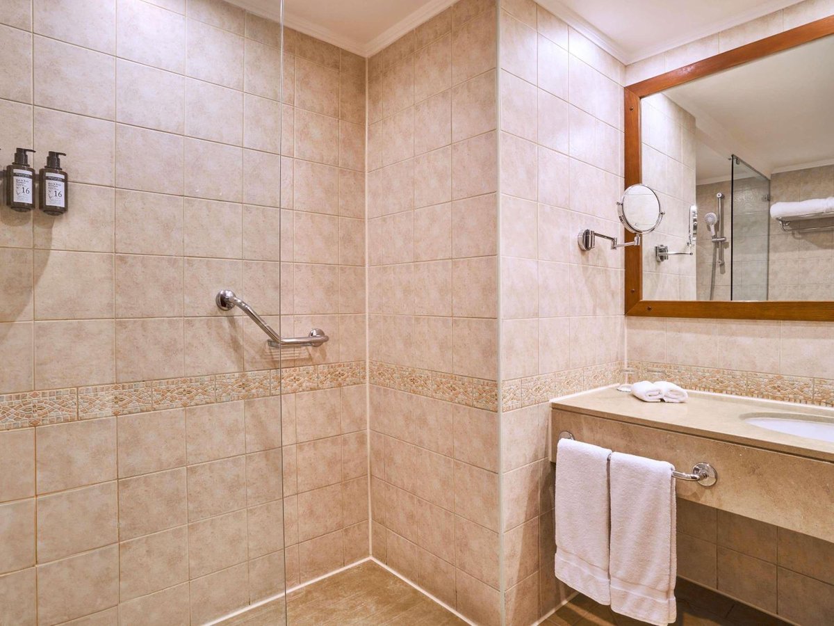 Movenpick Resort Aswan bathroom with a tiled shower and vanity.