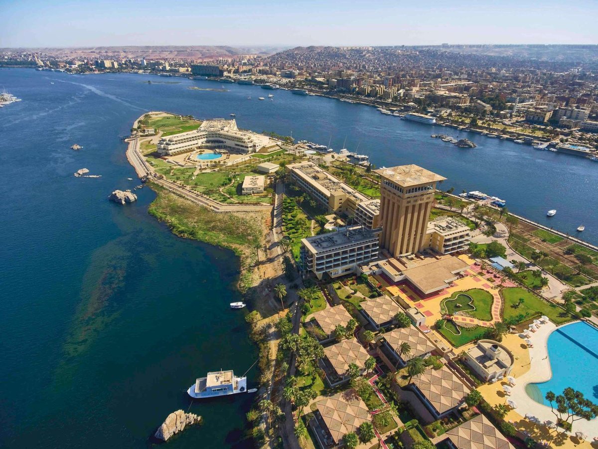 Movenpick Resort Aswan resort grounds with a tall tower and river views.