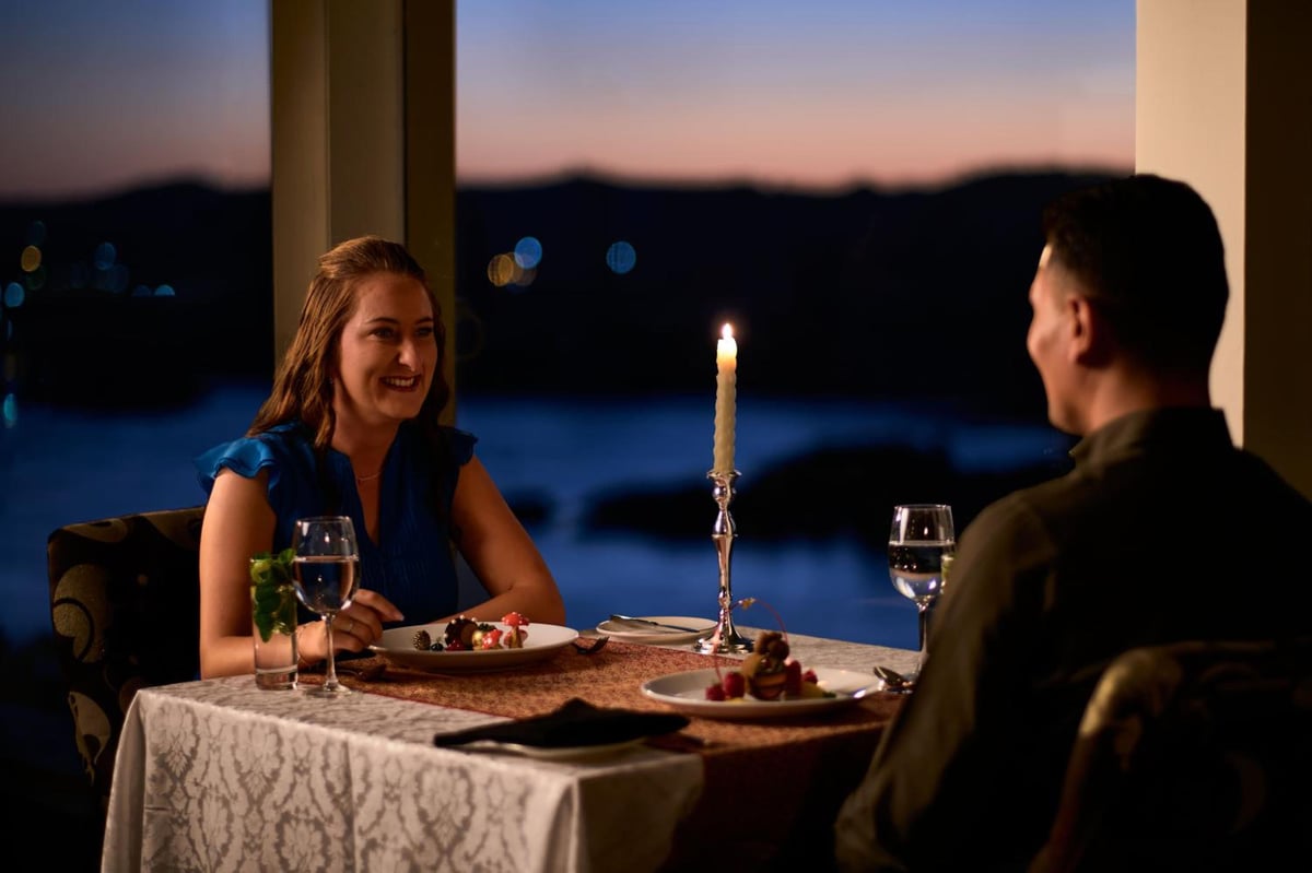 Movenpick Resort Aswan dining area with candlelight and a river view.