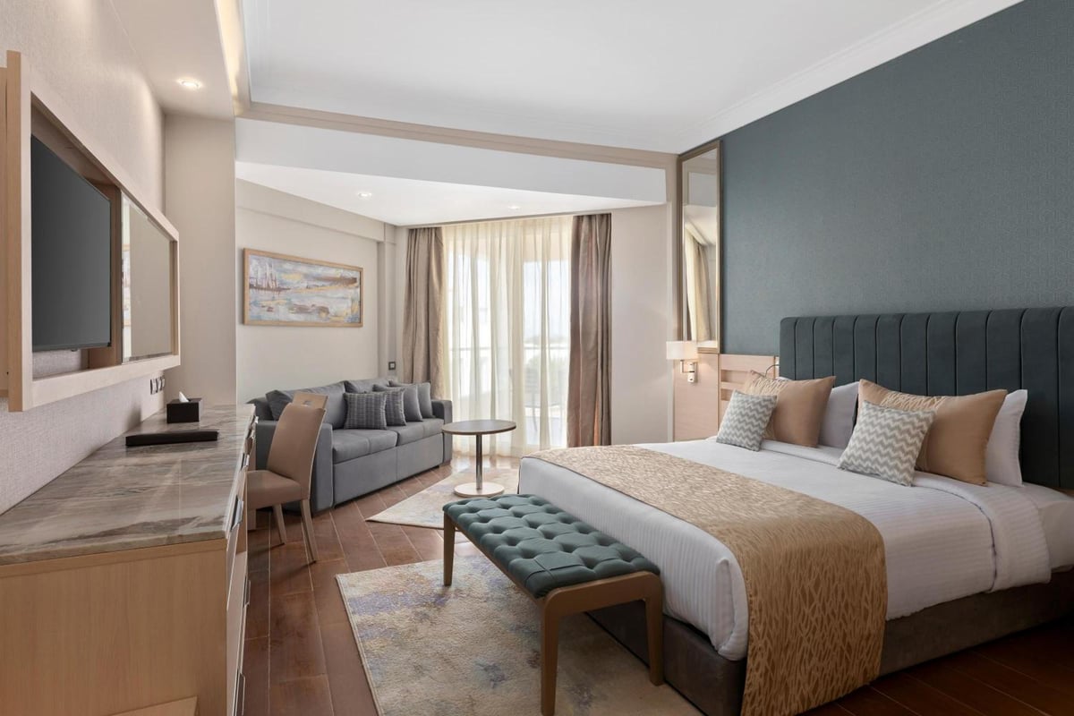 Xanadu Makadi Bay guest room with a large bed and a sitting area.