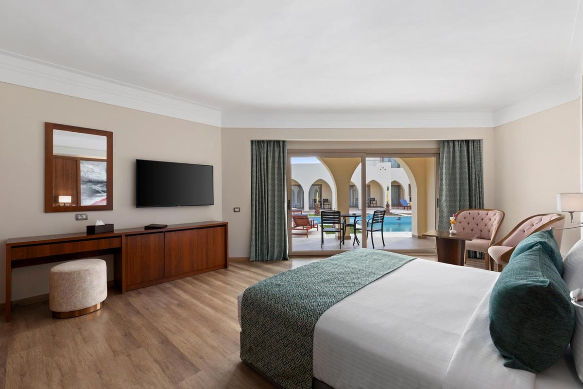 Xanadu Makadi Bay bedroom with a bed and sliding glass doors.
