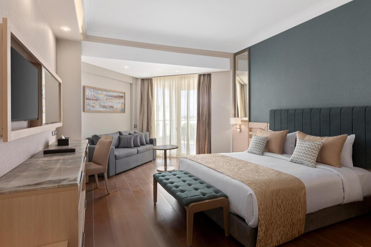 Xanadu Makadi Bay bedroom suite with a large bed and sitting area.