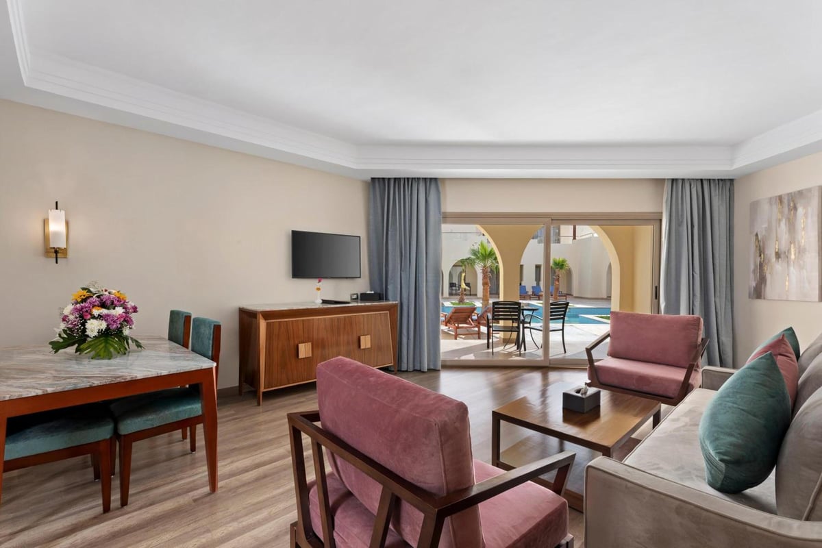 Xanadu Makadi Bay living area with glass doors and lounge seating.
