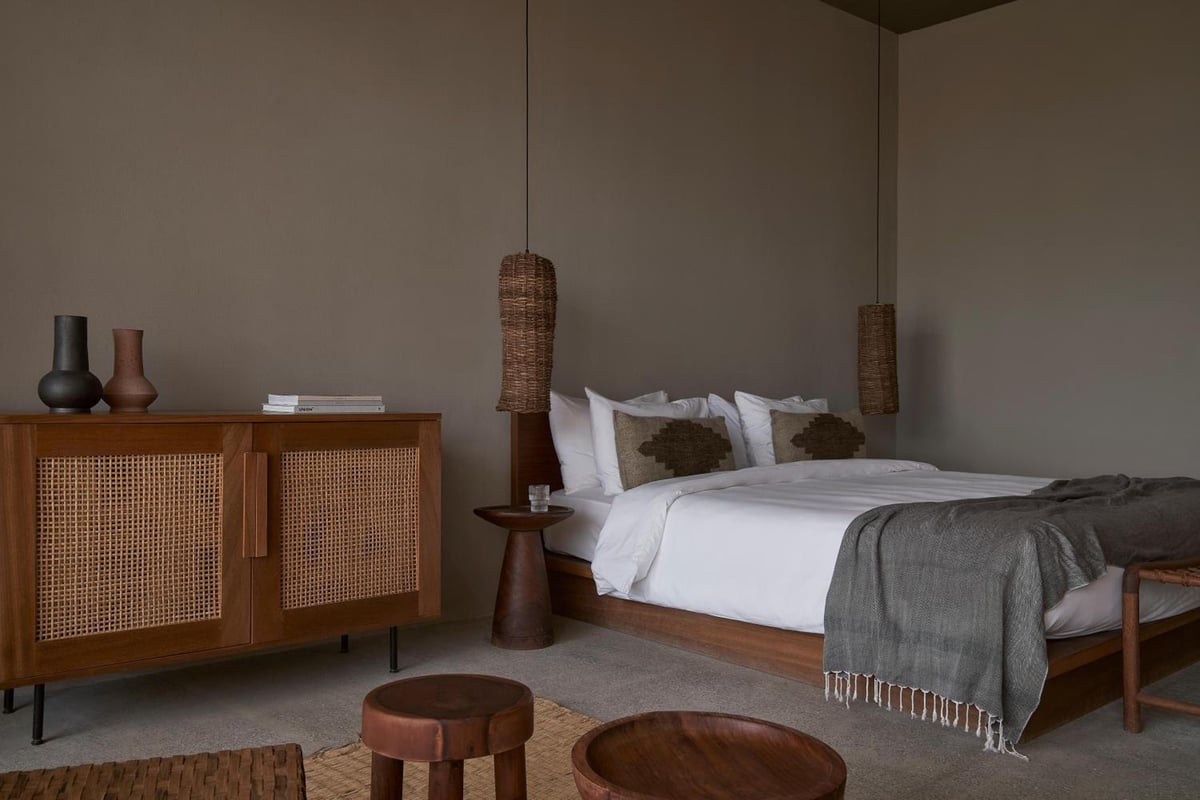 Casa Cook El Gouna (Adults Only) bedroom with a white bed and woven pendant lights.