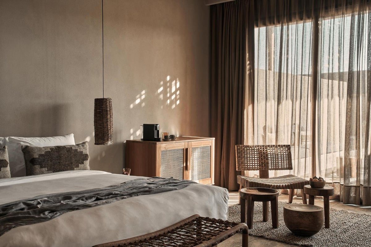 Casa Cook El Gouna (Adults Only) bedroom with a bed and woven chairs.