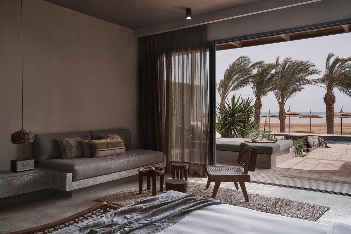 Casa Cook El Gouna (Adults Only) guest room with a sofa and open patio doors.
