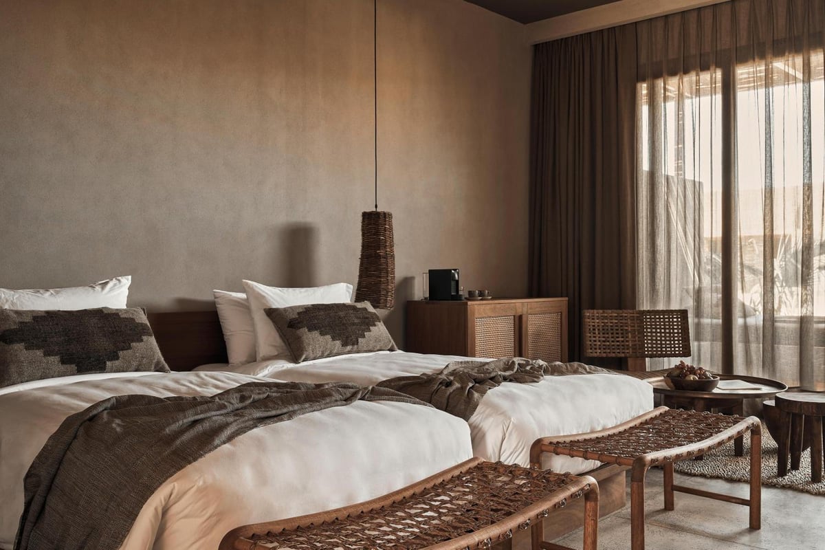 Casa Cook El Gouna (Adults Only) twin bedroom with two beds and woven benches.