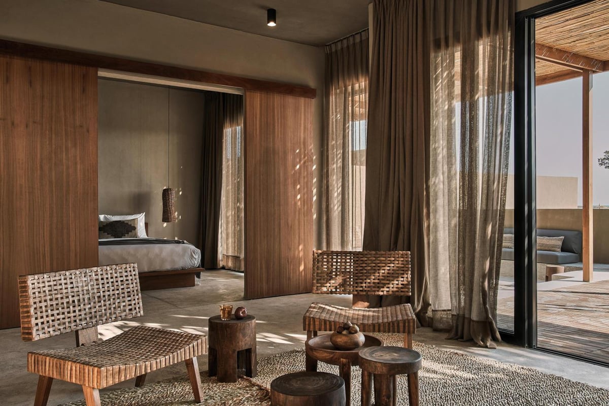 Casa Cook El Gouna (Adults Only) guest suite with woven seating and sliding glass doors.
