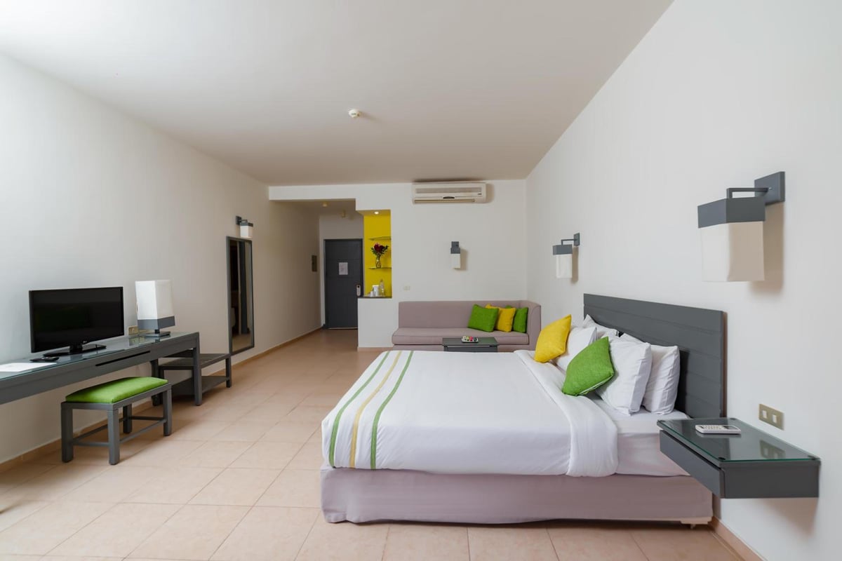 Lemon & Soul Makadi Garden guest room with a large bed and sitting area.