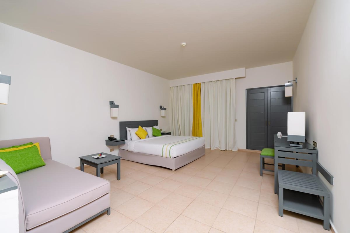 Lemon & Soul Makadi Garden guest room with a bed and sofa.