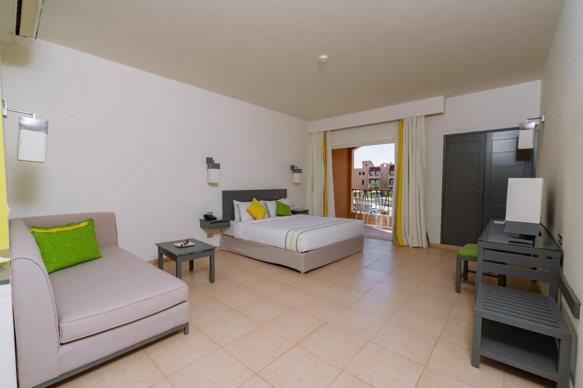 Lemon & Soul Makadi Garden guest room with a bed and balcony doors.