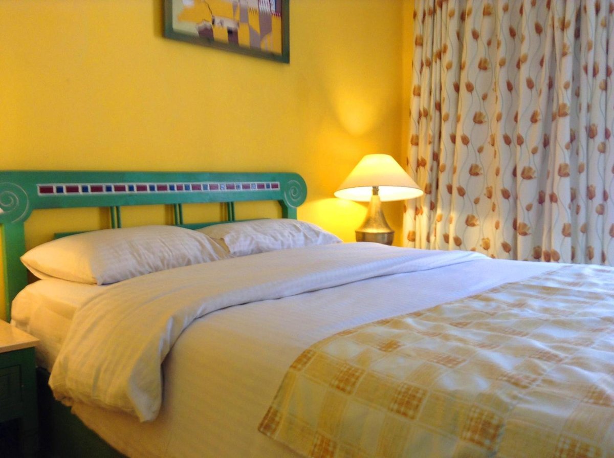 Giftun Azur Resort guest bedroom with a double bed and patterned curtains.