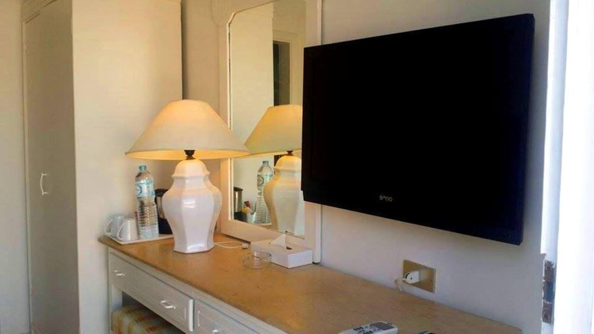 Giftun Azur Resort room with a mirrored console and wall-mounted television.