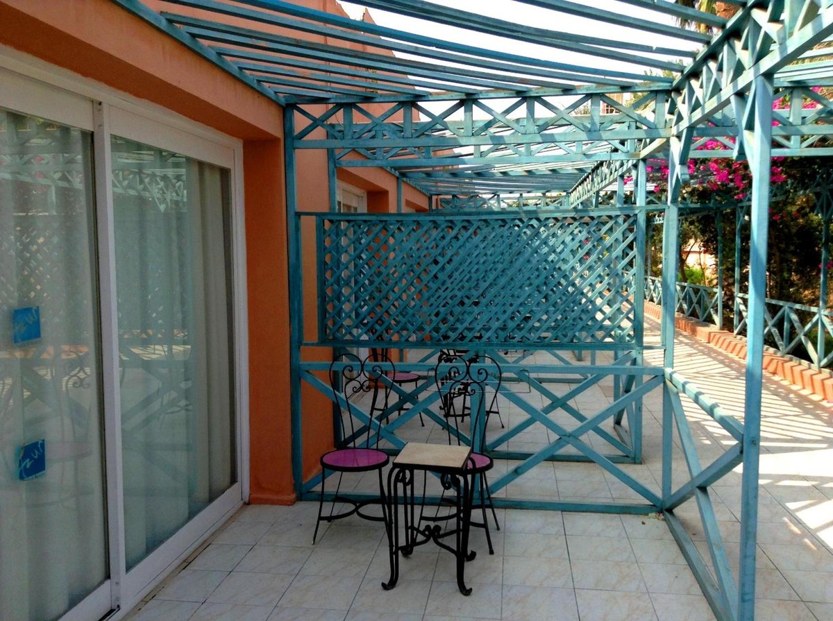 Giftun Azur Resort patio with a lattice screen and an overhead pergola.