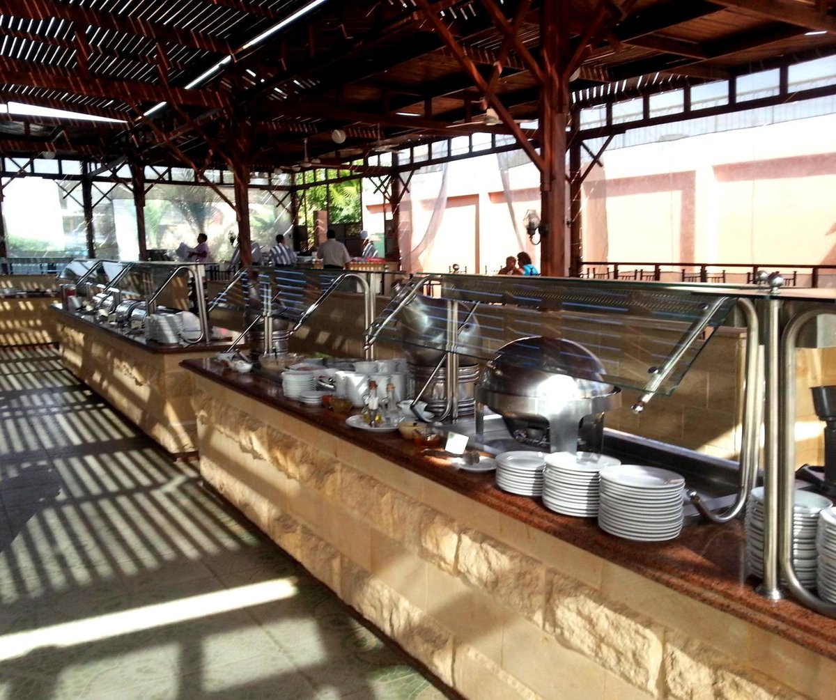 Giftun Azur Resort buffet area with serving counters and a slatted timber roof.