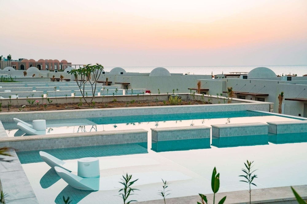 SENTIDO Reef Oasis Suakin Resort pool terrace with turquoise pools and in-water loungers.