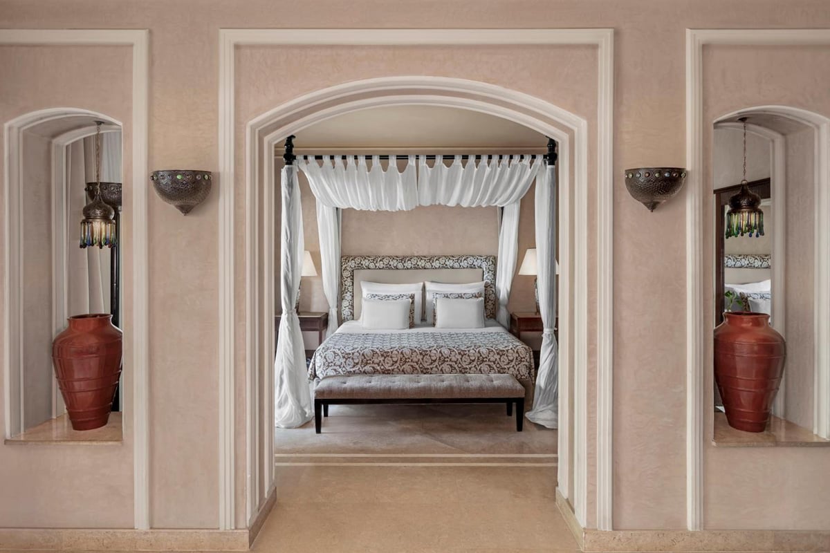 JAZ Makadi Star & Spa (Adults Only) bedroom with a canopy bed and white curtains.