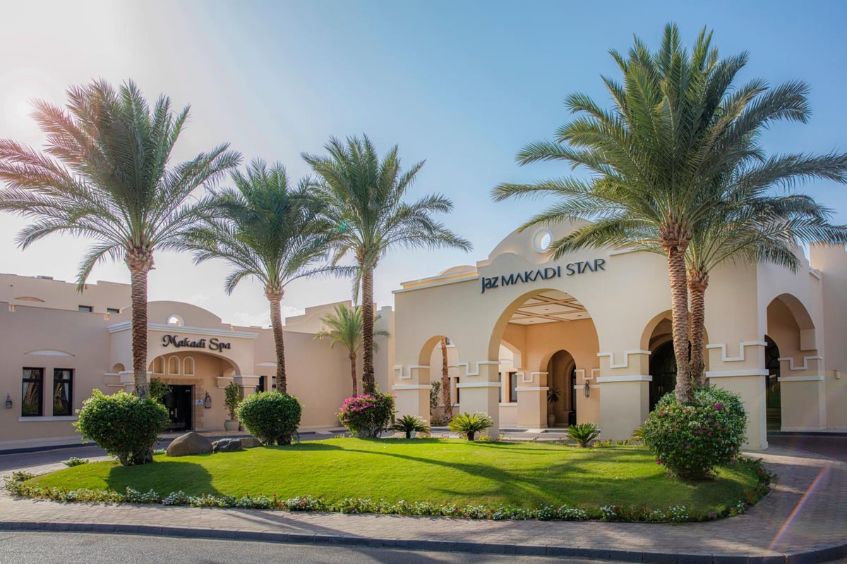 JAZ Makadi Star & Spa (Adults Only) hotel entrance with arched doorways and palm trees.
