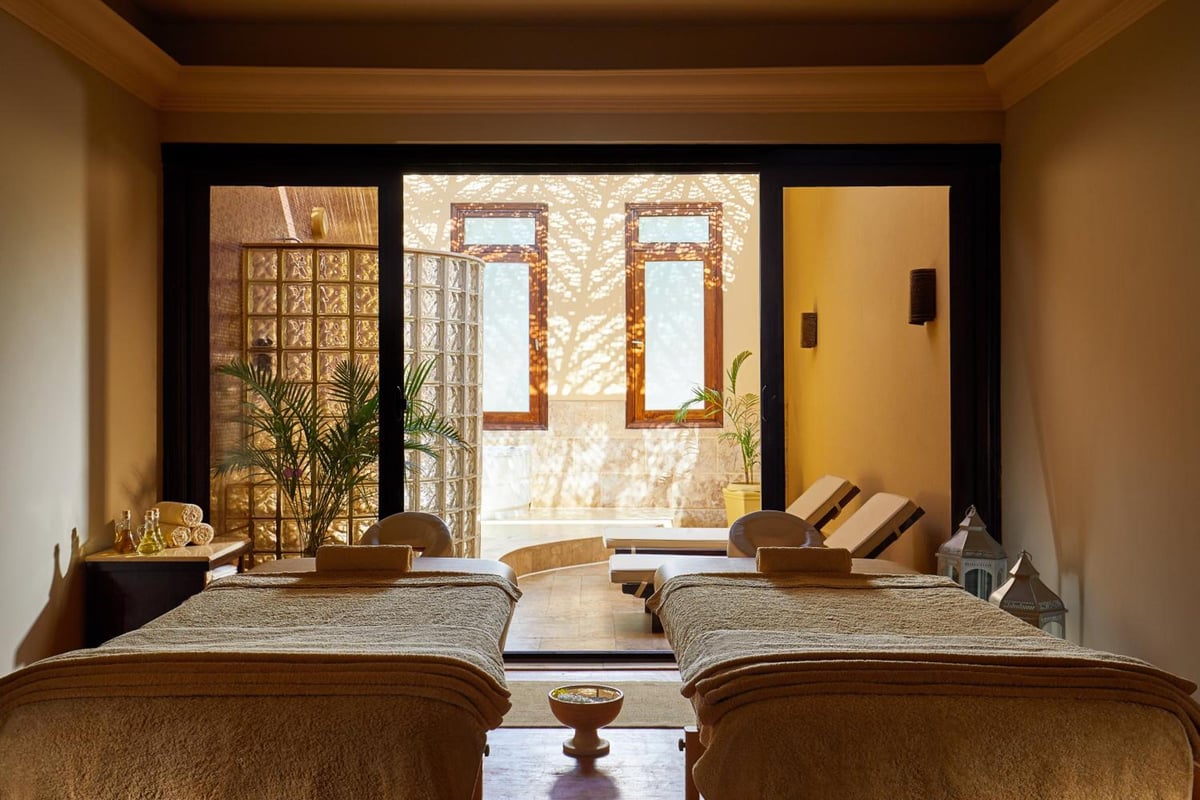 JAZ Makadi Star & Spa (Adults Only) spa treatment room with two massage tables and tall windows.