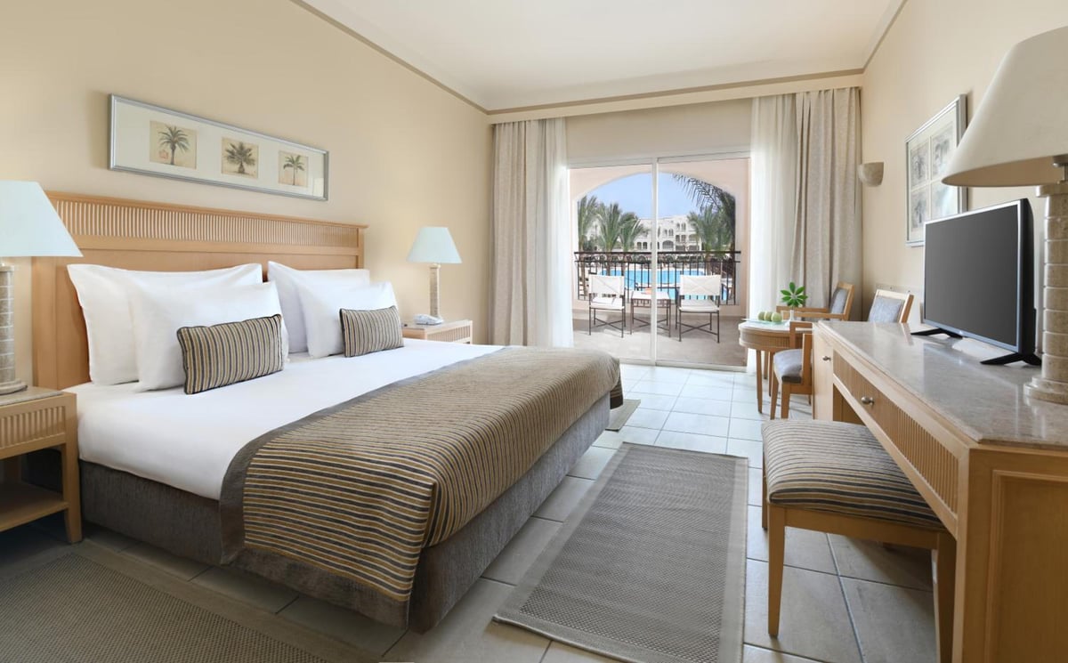 JAZ Makadi Star & Spa (Adults Only) guest room with a bed and a balcony.